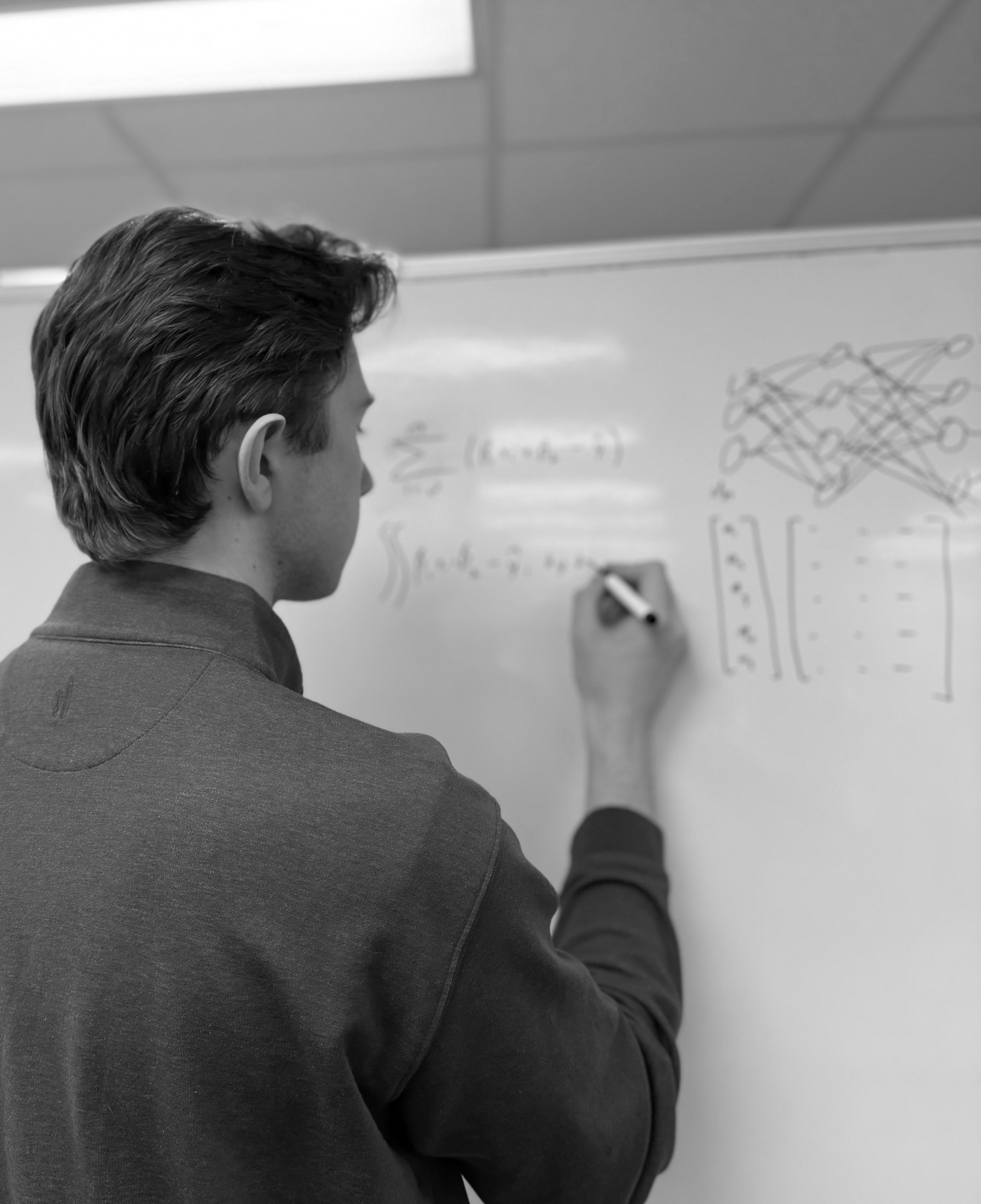 Team member writing on a whiteboard